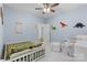 Bright ' bedroom with dinosaur decor, white furniture, and a comfortable seating area at 9801 Blackbird Hill Ln, Mint Hill, NC 28227