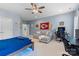 Large bedroom with a ceiling fan, TV, gamer setup, and comfortable seating area at 9801 Blackbird Hill Ln, Mint Hill, NC 28227
