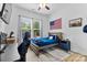 A cozy bedroom with wood accents, blue bedding, and natural light at 9801 Blackbird Hill Ln, Mint Hill, NC 28227