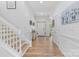 Inviting foyer with wood floors, neutral walls, a staircase, and a view of the front door at 9801 Blackbird Hill Ln, Mint Hill, NC 28227