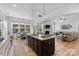 Open-concept kitchen with a large island, granite countertops, and a view of the Gathering room at 9801 Blackbird Hill Ln, Mint Hill, NC 28227