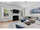 Comfortable living room with fireplace, large sectional, and view to the backyard at 9801 Blackbird Hill Ln, Mint Hill, NC 28227