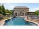 Back of house showing an in-ground pool, hot tub, and fenced yard, with ample space for recreation and relaxation at 9801 Blackbird Hill Ln, Mint Hill, NC 28227