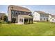 A fully-fenced, green backyard features a sunroom and patio at 1009 Hampton Grove Rd, Waxhaw, NC 28173