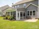 Spacious backyard with lush green grass, a screened-in porch, and a well-maintained exterior at 1009 Hampton Grove Rd, Waxhaw, NC 28173