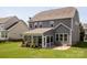 A large backyard features a sunroom, patio, and green lawn at 1009 Hampton Grove Rd, Waxhaw, NC 28173