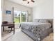 Comfortable bedroom with a ceiling fan, a desk with a chair and a window overlooking a beautiful lawn at 1009 Hampton Grove Rd, Waxhaw, NC 28173