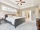 Bedroom with a connecting door to the bathroom, a ceiling fan, trey ceiling and large windows at 1009 Hampton Grove Rd, Waxhaw, NC 28173