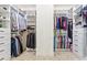 Spacious walk-in closet with custom white shelving, cabinets and rods for optimal storage at 1009 Hampton Grove Rd, Waxhaw, NC 28173