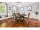 Elegant dining room with hardwood floors, neutral walls, and a modern chandelier at 1009 Hampton Grove Rd, Waxhaw, NC 28173