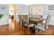 Well-lit dining room with hardwood floors and comfortable seating, seamlessly connecting to other living spaces at 1009 Hampton Grove Rd, Waxhaw, NC 28173