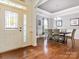 Charming dining room featuring hardwood floors, a stylish chandelier, and natural light at 1009 Hampton Grove Rd, Waxhaw, NC 28173