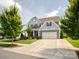Traditional two-story home with large driveway and manicured lawn at 1009 Hampton Grove Rd, Waxhaw, NC 28173