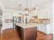 Bright kitchen featuring a large island, stainless steel appliances, and granite countertops at 1009 Hampton Grove Rd, Waxhaw, NC 28173