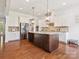 Bright kitchen featuring a large island, stainless steel appliances, and granite countertops at 1009 Hampton Grove Rd, Waxhaw, NC 28173