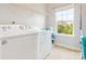 Laundry room with a large window and white washer and dryer appliances at 1009 Hampton Grove Rd, Waxhaw, NC 28173