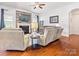 Living room with stone fireplace, ceiling fan, and gray sofa set at 1009 Hampton Grove Rd, Waxhaw, NC 28173