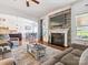 Comfortable living room with a stone fireplace and open view to the kitchen and breakfast nook at 1009 Hampton Grove Rd, Waxhaw, NC 28173