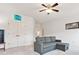 Bright living room with a gray sectional sofa, large windows, double closets and an open doorway at 1009 Hampton Grove Rd, Waxhaw, NC 28173