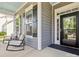 Inviting front porch with comfortable seating, stylish shutters, and a black front door at 1009 Hampton Grove Rd, Waxhaw, NC 28173