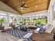 Inviting sunroom featuring wicker furniture, wood ceiling, large windows and a beautiful outdoor view at 1009 Hampton Grove Rd, Waxhaw, NC 28173