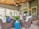 Comfortable sunroom with wicker furniture, wood ceiling, large windows and a beautiful outdoor view at 1009 Hampton Grove Rd, Waxhaw, NC 28173