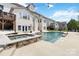 Picturesque backyard featuring a sparkling pool and spa with beautiful stone accents at 1009 Murandy Ln, Matthews, NC 28104