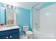 Bathroom featuring blue cabinets and a shower with bathtub at 1009 Murandy Ln, Matthews, NC 28104