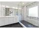 Bright bathroom featuring a glass enclosed shower with a showerhead and dual sink vanity with white cabinetry at 1009 Murandy Ln, Matthews, NC 28104