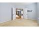 Bright bedroom with double doors and neutral carpet, leading to the living area at 1009 Murandy Ln, Matthews, NC 28104