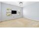 Carpeted bedroom with two windows and ceiling light fixture at 1009 Murandy Ln, Matthews, NC 28104