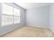 Neutral bedroom with carpet, a large window, and plenty of natural light at 1009 Murandy Ln, Matthews, NC 28104