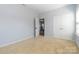 Neutral bedroom features a large closet and a view into the hallway at 1009 Murandy Ln, Matthews, NC 28104