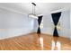 Bright, spacious dining room with hardwood floors, wainscoting, and modern light fixture at 1009 Murandy Ln, Matthews, NC 28104