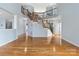Stunning foyer features a beautiful staircase with ornamental wrought iron and gleaming hardwood floors at 1009 Murandy Ln, Matthews, NC 28104