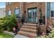 Inviting brick front porch with double doors, decorative plants, and 'Welcome' sign at 1009 Murandy Ln, Matthews, NC 28104