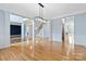 Open-concept living area with hardwood floors, columns, and a view of the staircase at 1009 Murandy Ln, Matthews, NC 28104