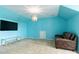 Large living room with blue walls, a couch and a TV at 1009 Murandy Ln, Matthews, NC 28104