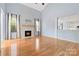 Open living room with hardwood floors, modern fireplace, and bright kitchen in view at 1009 Murandy Ln, Matthews, NC 28104
