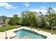 Inviting in-ground pool surrounded by lush landscaping, creating a private backyard retreat at 1009 Murandy Ln, Matthews, NC 28104