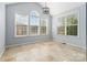 Bright sunroom with tile flooring and an abundance of natural light from large windows at 1009 Murandy Ln, Matthews, NC 28104