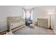 Charming Bedroom with crib, changing table, and a cozy accent chair at 1045 Fairway Ridge Nw Rd, Concord, NC 28027