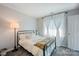 Cozy bedroom featuring a metal frame bed, neutral tones, and soft natural light at 1045 Fairway Ridge Nw Rd, Concord, NC 28027