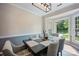 Dining room with modern chandelier, neutral color scheme, and natural light from bay window at 1045 Fairway Ridge Nw Rd, Concord, NC 28027