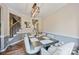 Dining room with modern chandelier and table; features staircase and hall access to kitchen at 1045 Fairway Ridge Nw Rd, Concord, NC 28027