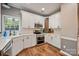 Modern kitchen featuring white cabinets, stainless steel appliances, and hardwood floors at 1045 Fairway Ridge Nw Rd, Concord, NC 28027