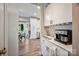 Well-lit kitchen area flowing into an adjacent room at 1045 Fairway Ridge Nw Rd, Concord, NC 28027