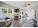 Spacious living room with fireplace, wood floors, and views to the backyard at 1045 Fairway Ridge Nw Rd, Concord, NC 28027
