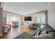 Bright and spacious living room with hardwood floors, a large sectional sofa, and a large bay window at 1045 Fairway Ridge Nw Rd, Concord, NC 28027