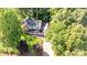 Aerial view of house showing lush landscaping, mature trees, and manicured lawn at 110 Club Dr, Mooresville, NC 28115